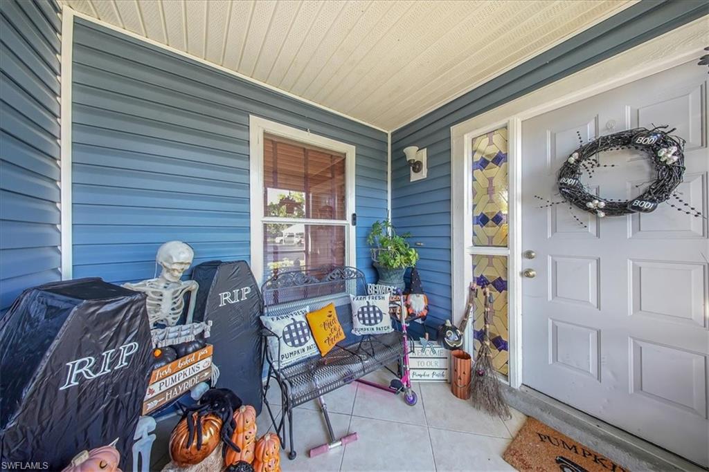 3408 Timberwood Circle, Unit 1360 Naples, FL 34105 - Photo 33 of 36 a front view of a house with outdoor seating