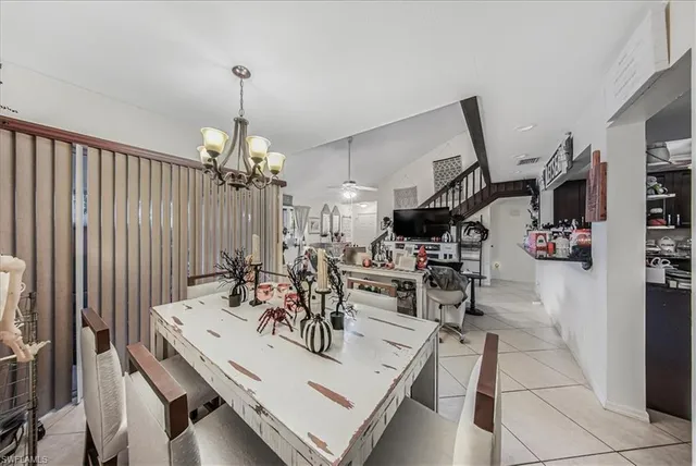 a view of a dining room with furniture and a chandelier