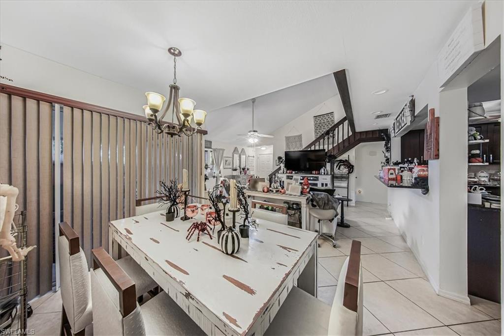 3408 Timberwood Circle, Unit 1360 Naples, FL 34105 - Photo 6 of 36 a view of a dining room with furniture and a chandelier