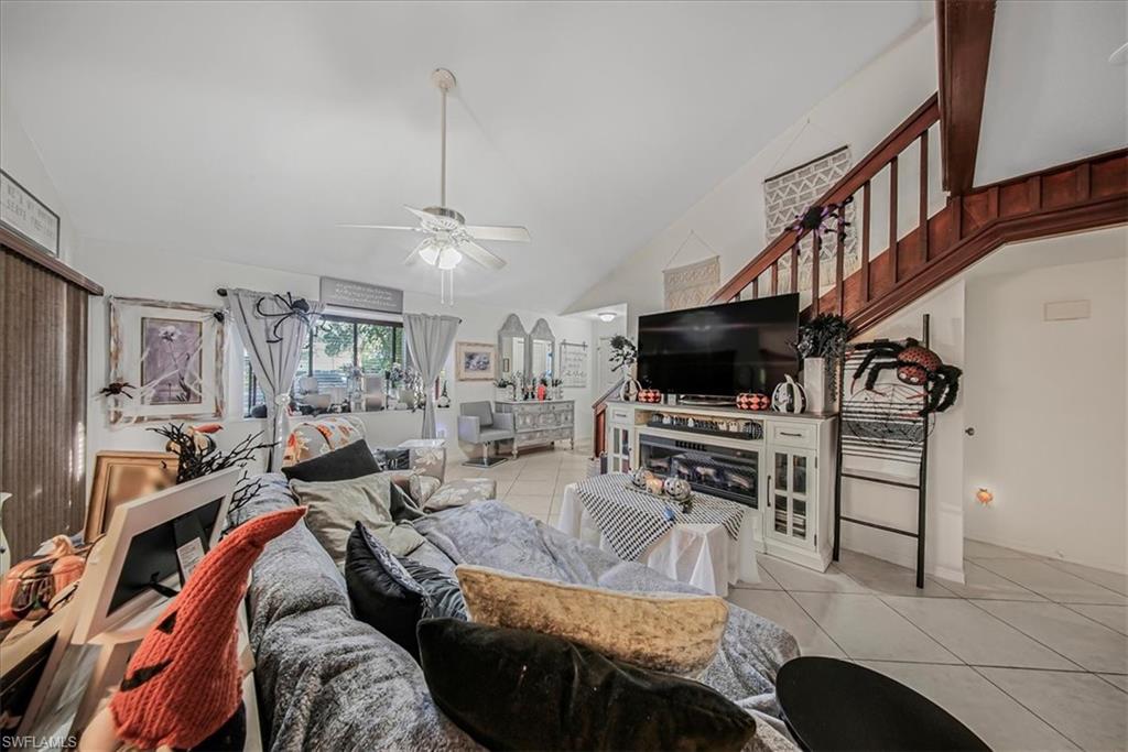 3408 Timberwood Circle, Unit 1360 Naples, FL 34105 - Photo 9 of 36 a living room with furniture and a flat screen tv