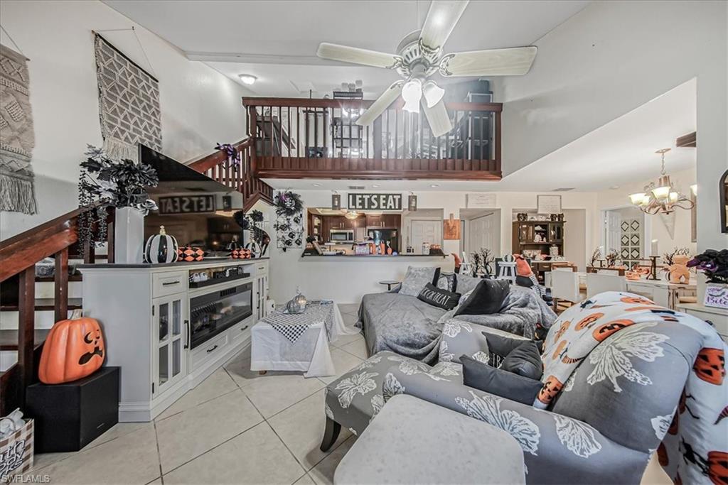 3408 Timberwood Circle, Unit 1360 Naples, FL 34105 - Photo 10 of 36 a living room filled with furniture and a chandelier