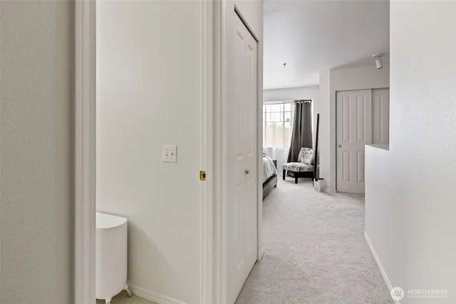 a view of a hallway with wooden shelves