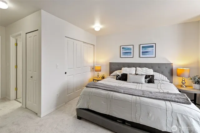 a bedroom with a large bed and a chandelier