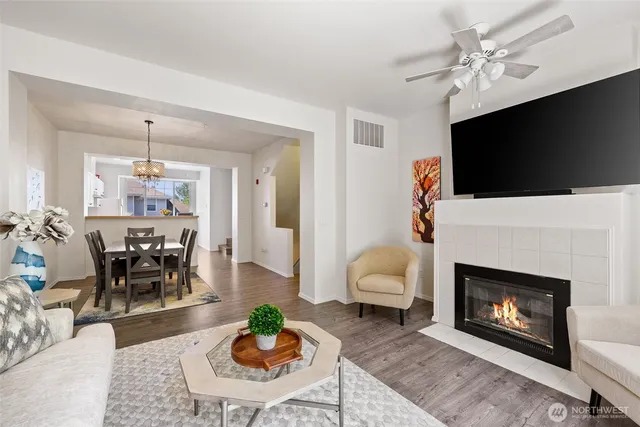 a living room with furniture a flat screen tv and a fireplace