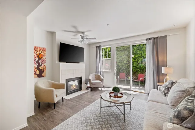 a living room with furniture a fireplace and a flat screen tv