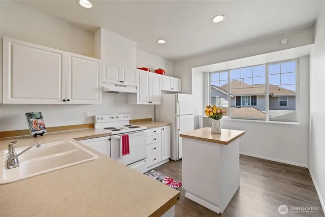 a kitchen that has a sink and a stove in it