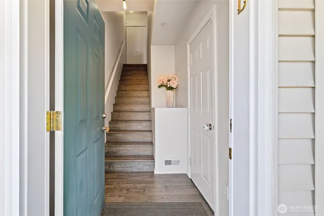 a view of a hallway with wooden floor and entryway