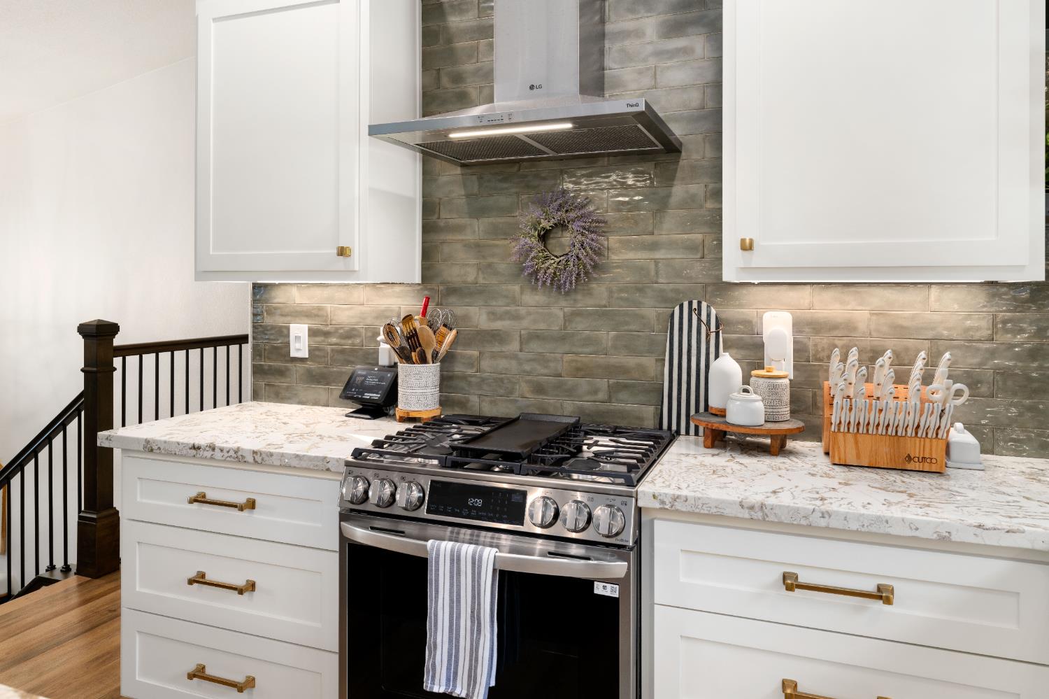 1130 Summer Ridge Court Auburn, CA 95603 - Photo 15 of 56 a kitchen with granite countertop a stove oven and white cabinets