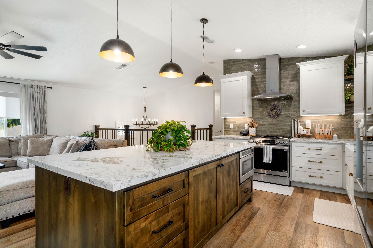 1130 Summer Ridge Court Auburn, CA 95603 - Photo 16 of 56 a kitchen with stainless steel appliances kitchen island a large island in the center and wooden floor