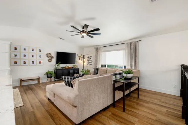 a dining room with furniture and a large window