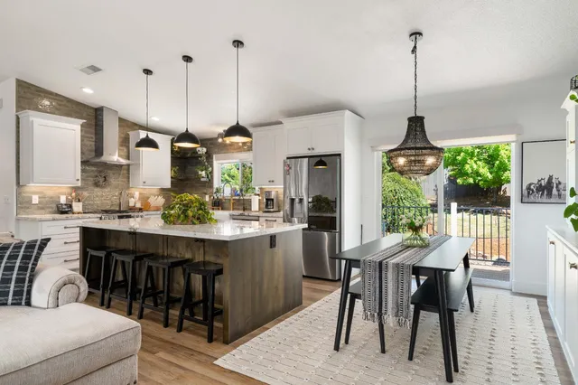 a view of a house with swimming pool and sitting area