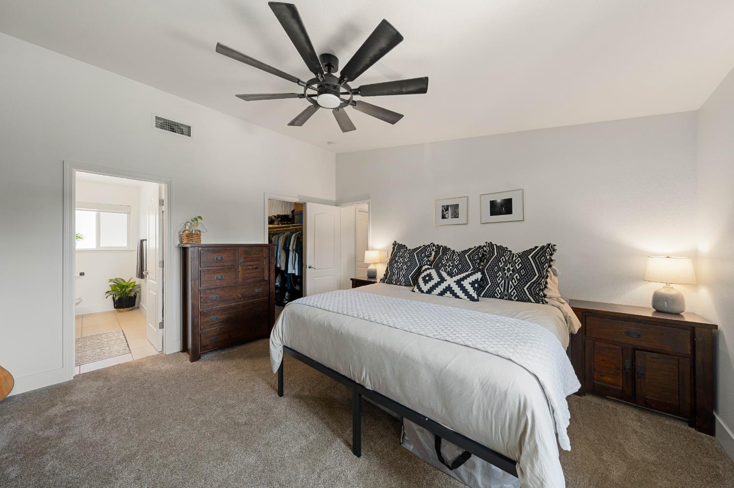 1130 Summer Ridge Court Auburn, CA 95603 - Photo 31 of 56 a bedroom with a bed and a chandelier