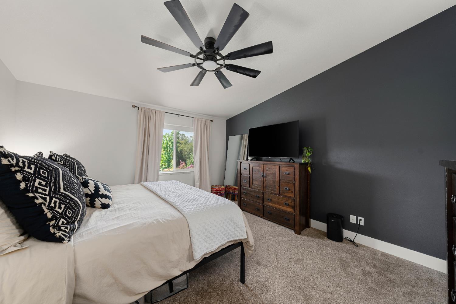 1130 Summer Ridge Court Auburn, CA 95603 - Photo 33 of 56 a bedroom with a bed and a flat tv screen on a dresser