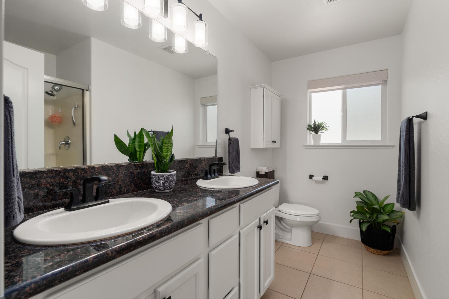 1130 Summer Ridge Court Auburn, CA 95603 - Photo 34 of 56 a bathroom with a granite countertop sink and a mirror