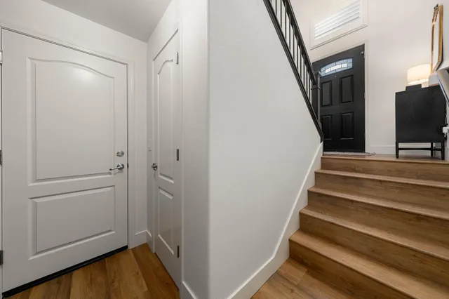 a view of a balcony with wooden floor and fence