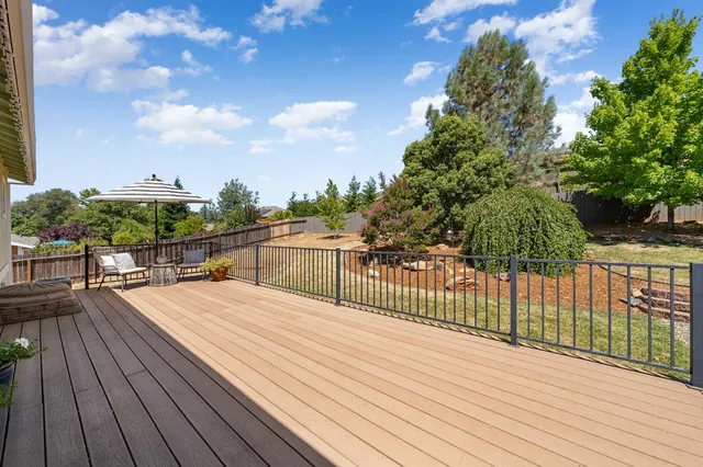 a backyard of a house with table and chairs