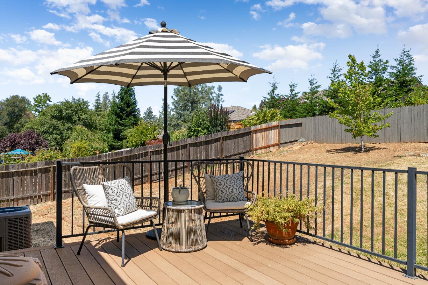 1130 Summer Ridge Court Auburn, CA 95603 - Photo 47 of 56 a deck with wooden floor a yard a table and chairs