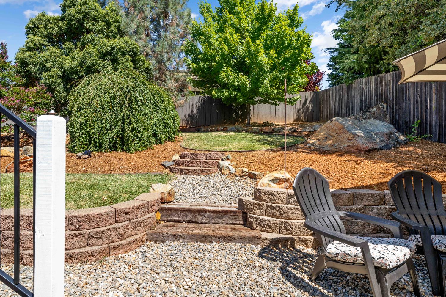 1130 Summer Ridge Court Auburn, CA 95603 - Photo 48 of 56 a view of a patio with table and chairs with wooden fence and plants