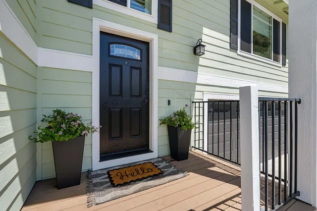 a kitchen with kitchen island a dining table chairs stainless steel appliances and cabinets