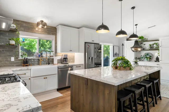 a dining room with furniture a chandelier and wooden floor