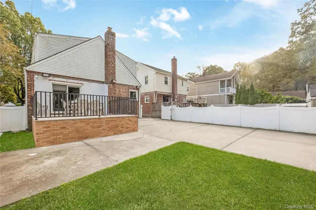 a view of an house with backyard and road