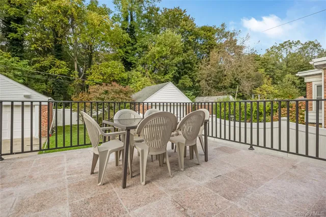 a view of a chairs and table in the back yard of the house