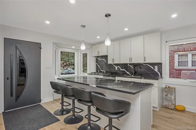 a kitchen with a table chairs sink and cabinets