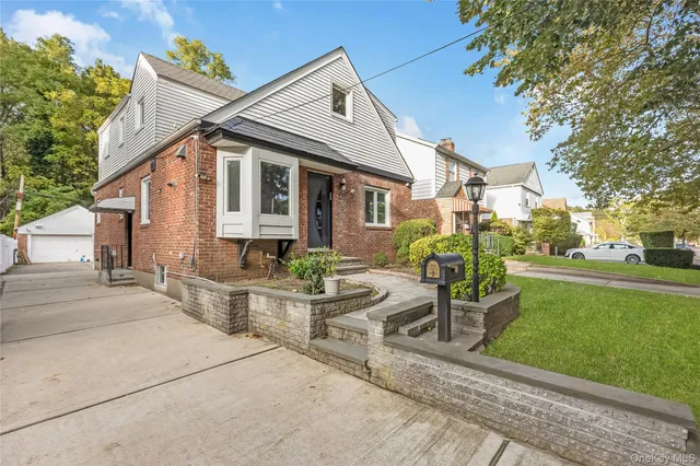 a front view of house with yard and outdoor seating
