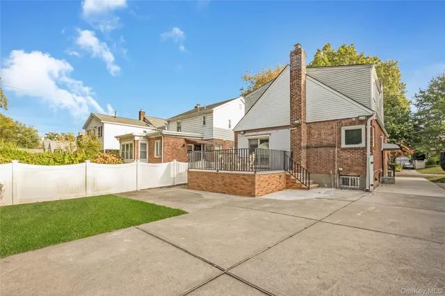 a view of a house with a swimming pool and a yard
