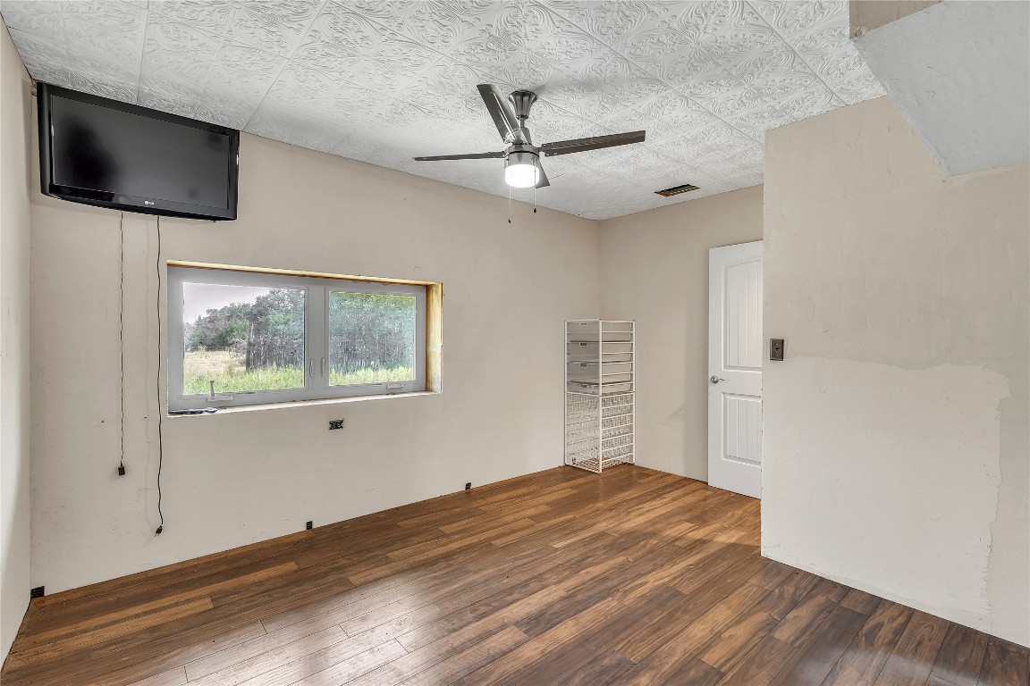 1228 Stanton Ranch Loop Johnson City, TX 78636 - Photo 12 of 17 an empty room with wooden floor and windows