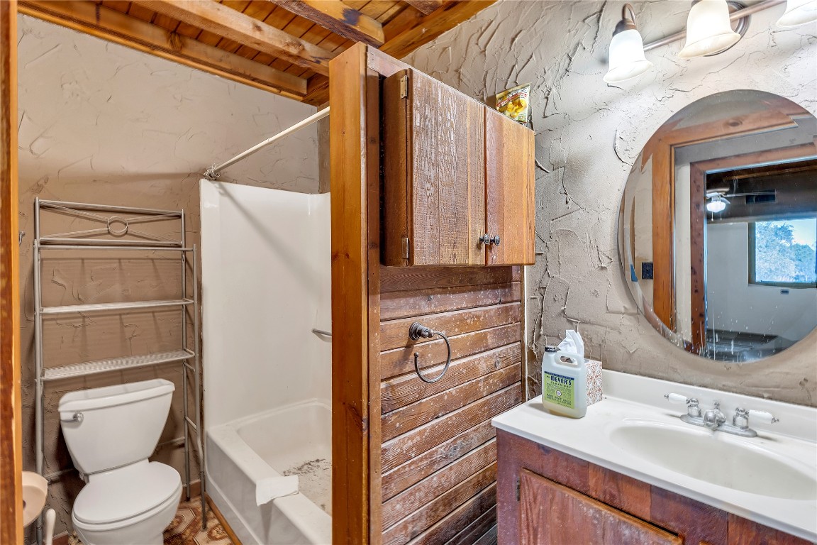 1228 Stanton Ranch Loop Johnson City, TX 78636 - Photo 6 of 17 a bathroom with a granite countertop sink toilet and shower