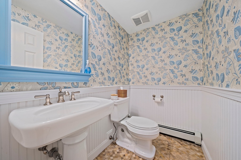 21 Old Coach Road Canton, MA 02021 - Photo 17 of 42 a bathroom with a toilet sink and mirror