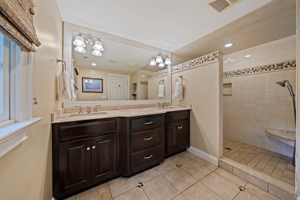 21 Old Coach Road Canton, MA 02021 - Photo 21 of 42 a spacious bathroom with a granite countertop sink mirror and a shower