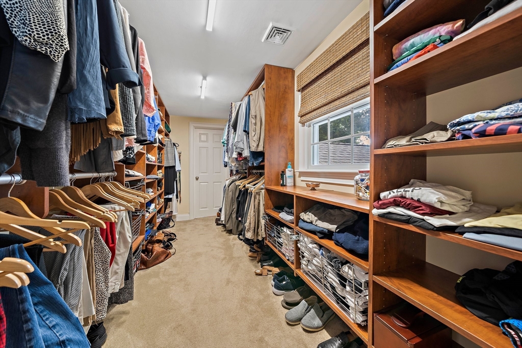 21 Old Coach Road Canton, MA 02021 - Photo 22 of 42 a view of walk in closet with clothes and shoes
