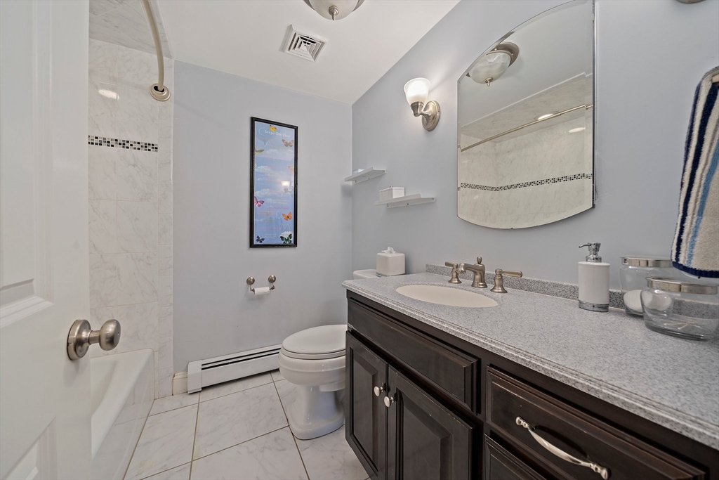21 Old Coach Road Canton, MA 02021 - Photo 28 of 42 a bathroom with a granite countertop sink a toilet and mirror