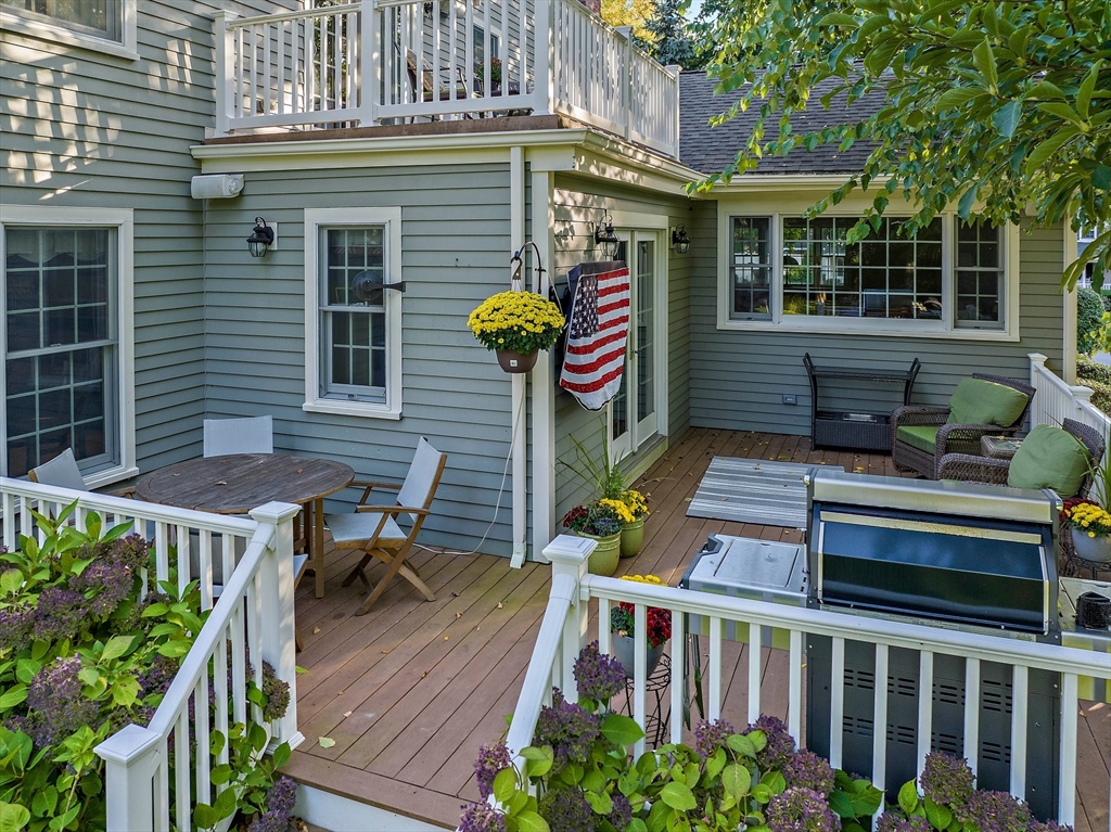 21 Old Coach Road Canton, MA 02021 - Photo 38 of 42 a roof deck with table and chairs potted plants and wooden floor