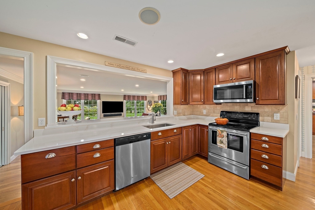 21 Old Coach Road Canton, MA 02021 - Photo 4 of 42 a kitchen with wooden cabinets and stainless steel appliances