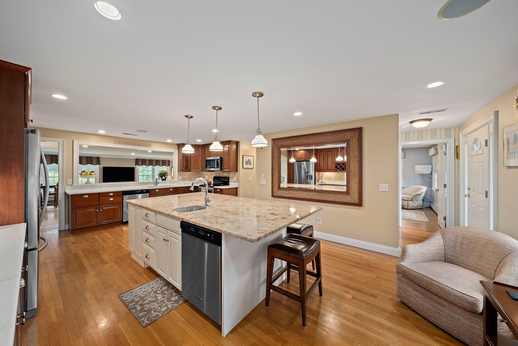 21 Old Coach Road Canton, MA 02021 - Photo 6 of 42 a large kitchen with kitchen island a large counter space a sink stainless steel appliances and cabinets