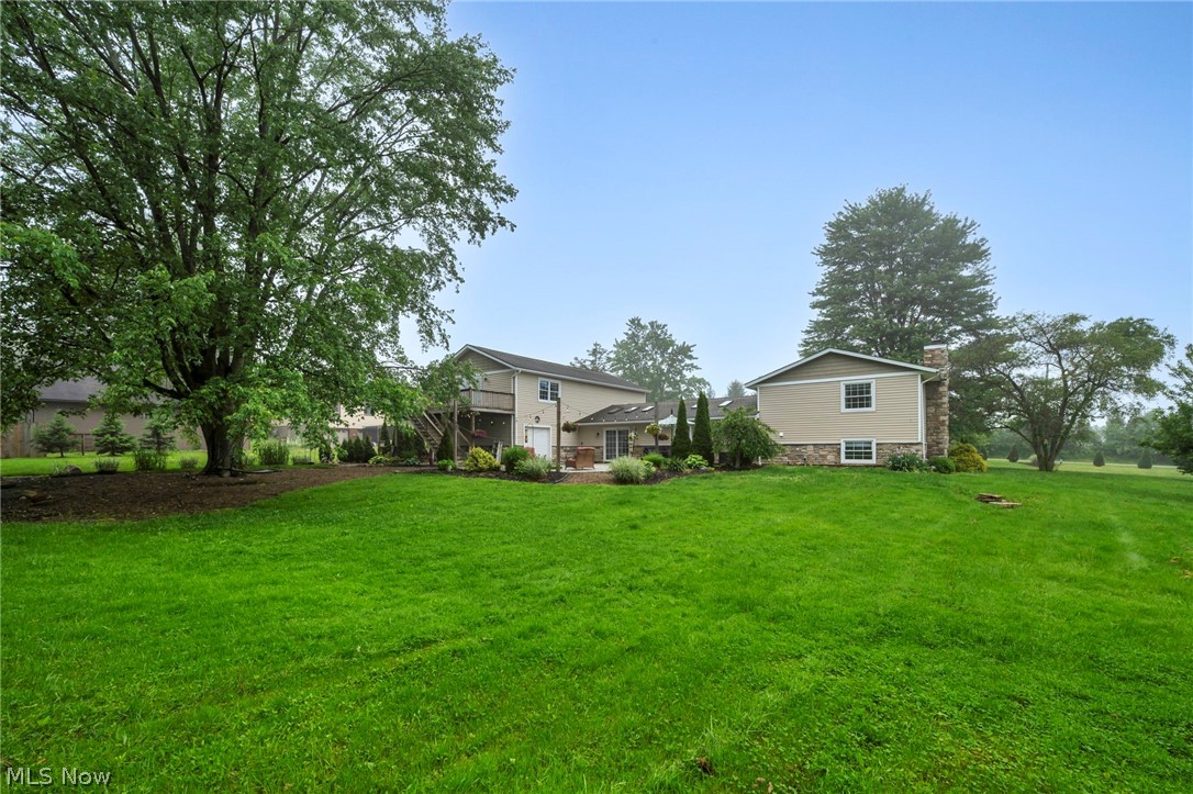 7996 Buffham Road Lodi, OH 44254 - Photo 42 of 50 Expansive green lawn surrounds the property, featuring mature trees and landscaped beds