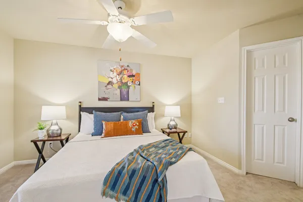 a bedroom with a bed and a chandelier