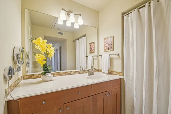 a bathroom with a double vanity sink and a mirror