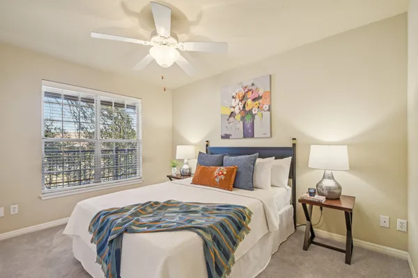 a bedroom with a bed and a window