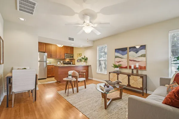 a living room with furniture and kitchen view