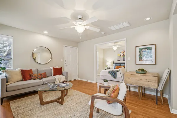 a living room with furniture a rug and a chandelier