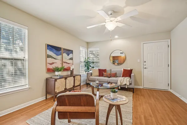 a living room with furniture and wooden floor
