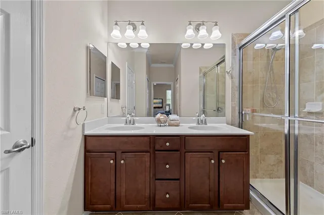 a bathroom with a double vanity sink and a mirror