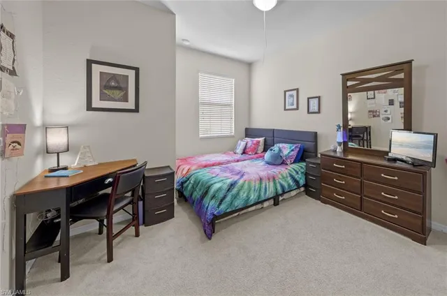 a bedroom with a bed and a table in it