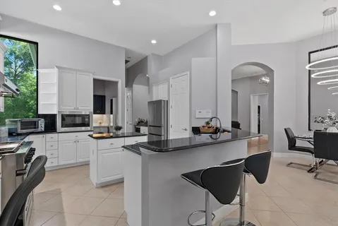 a kitchen with a sink and white cabinets