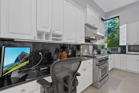 a kitchen with a sink dishwasher a refrigerator and cabinets