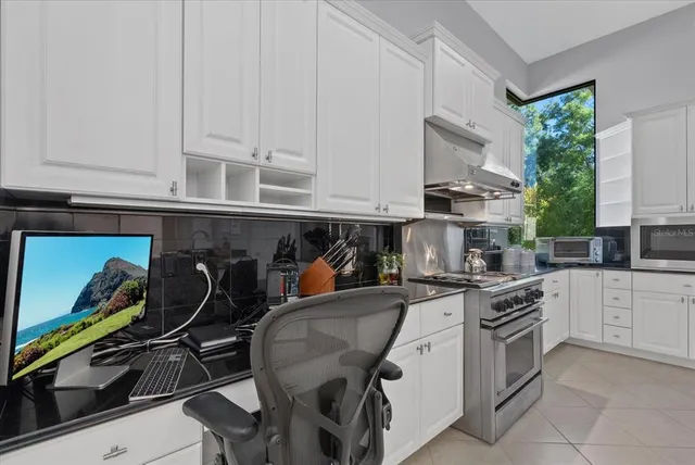 a kitchen with a sink dishwasher a refrigerator and cabinets